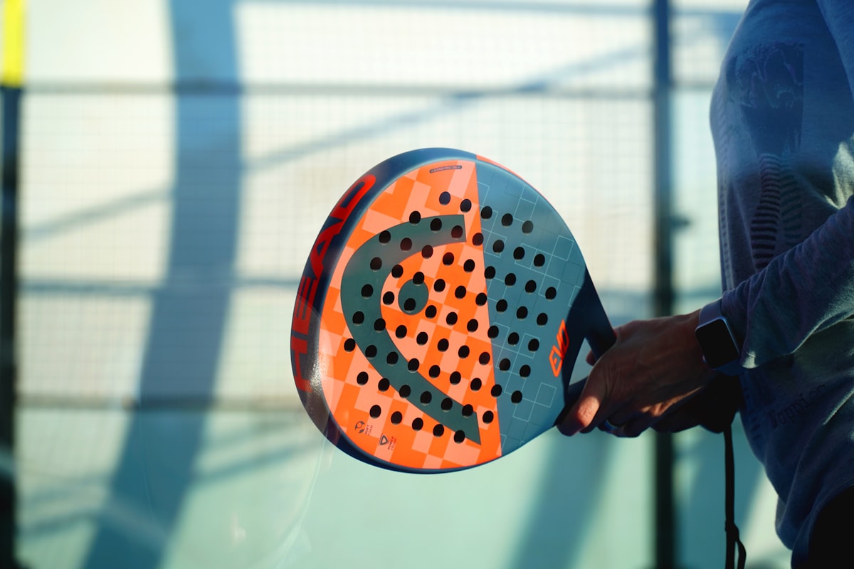 Padel racket on an indoor padel court, bookings taken by an AI phone line